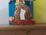 Jaycees Montana Cowboy In Brown Chaps & Yellow Vest Holding Whiskey Bottle .	PIN