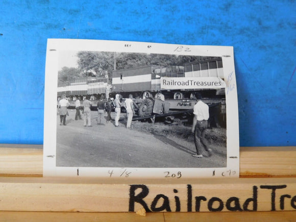 Photo Circus cars on railroad flat cars.  Lots of people walking around people