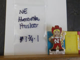 Jaycees Nebraska Harrietta Husker In White Shirt W/Football On White Base - On-T