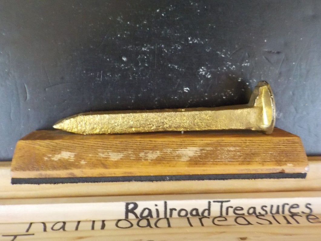 Railroad Spike on wood Gold in color – RailroadTreasures